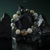 Phantom & Moonstone Energy Bracelet on black stones, blending dark and light beads for balance and positive energy.