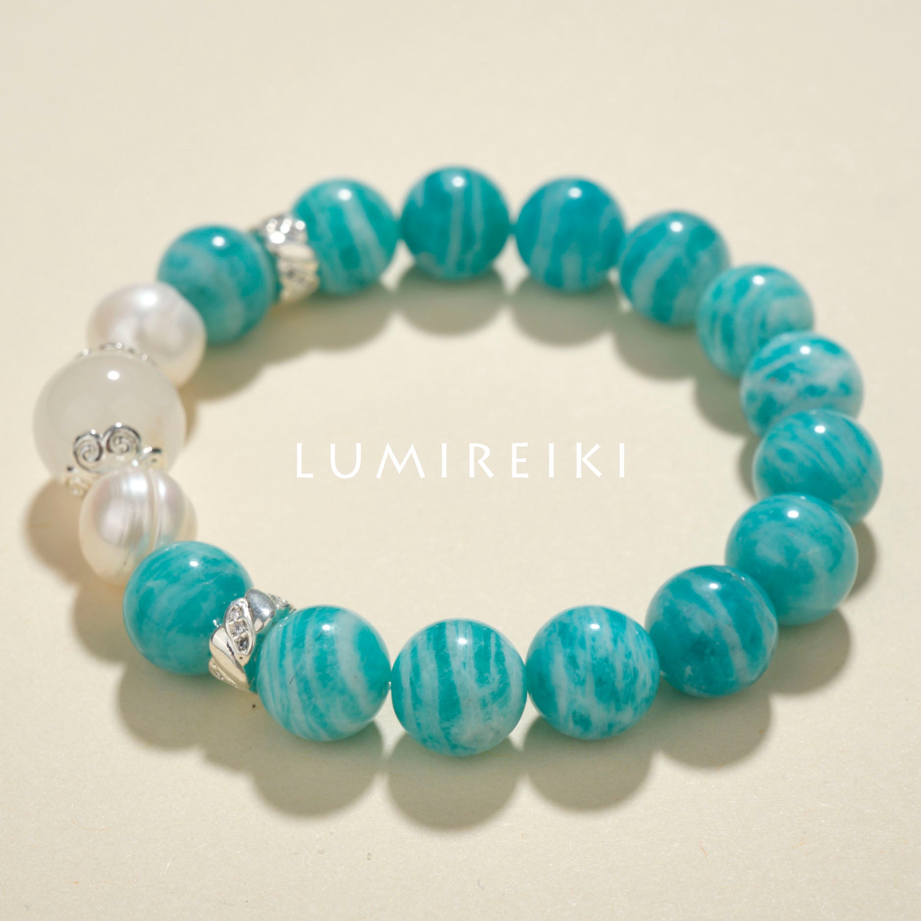 Amazonite Courage Boost Bracelet with blue amazonite beads, milky white crystal, and pearls promoting calm and confidence.