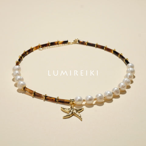 Pearl Tranquil Necklace featuring 10-11mm pearls and 4x13mm cylinders with a gold starfish charm for elegance and calm.