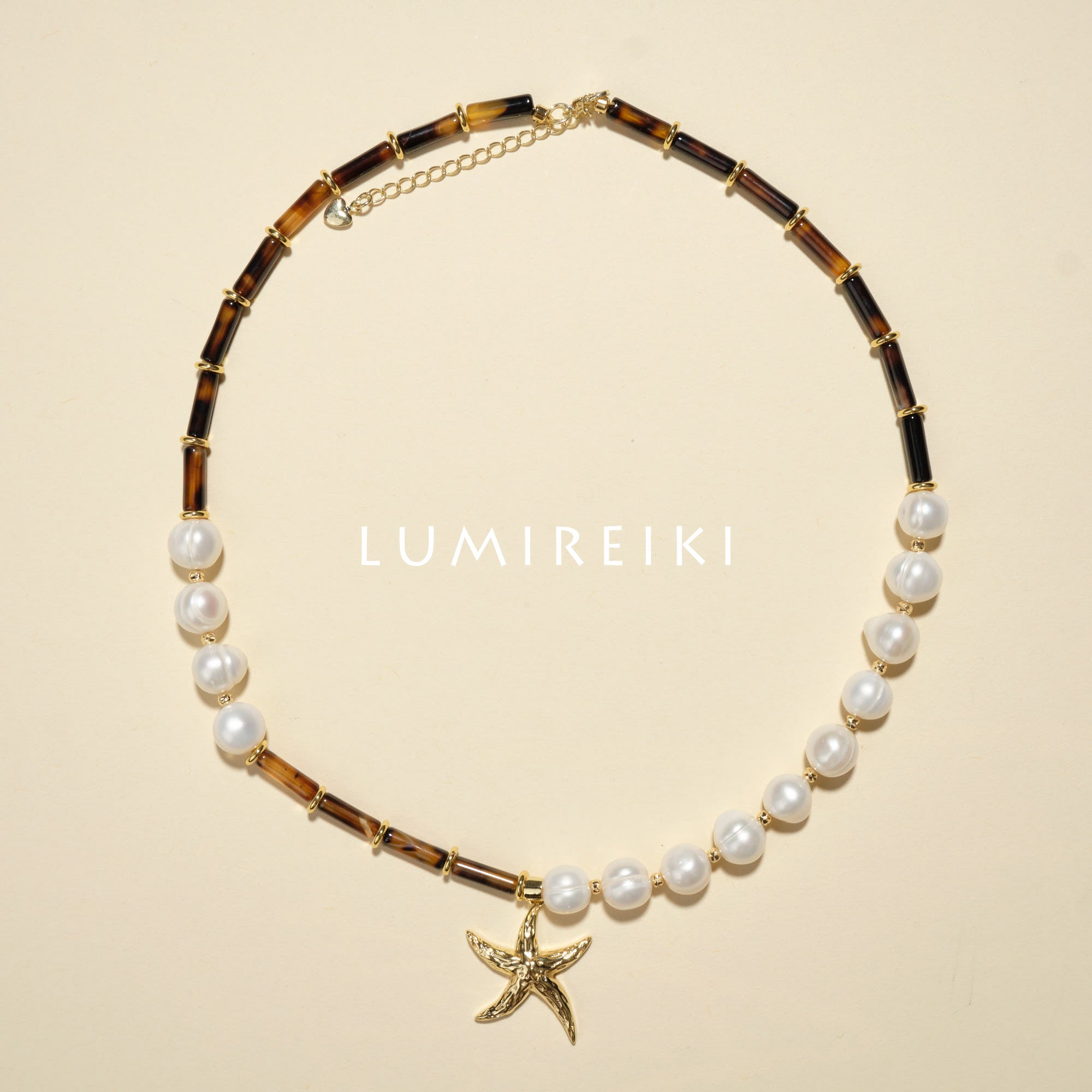 Pearl Tranquil Necklace featuring 10-11mm pearls and 4x13mm cylinders with a starfish charm for elegance and calm.