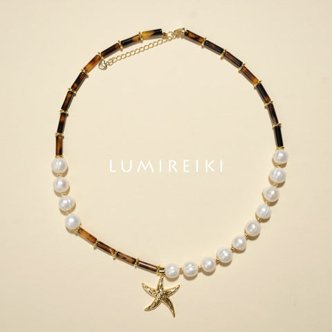 Pearl Tranquil Necklace featuring 10-11mm pearls and 4x13mm cylinders with a starfish charm for elegance and calm.